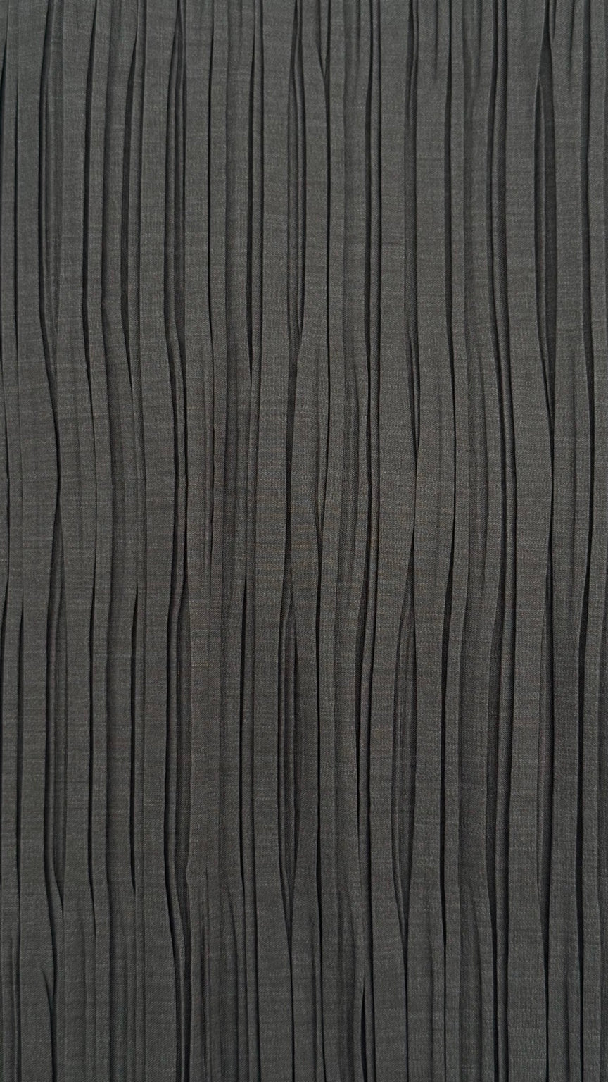 Close-up of grey pleated fabric used in the MESNIKOVICH PLISSÉ / 01 collection