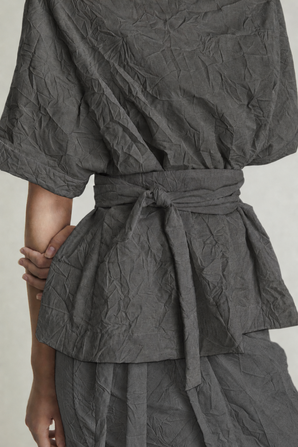 AI-assisted colour visualisation of TOP CRUMPLED / 07 in grey, with a matching grey skirt.